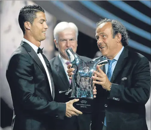  ?? AP. ?? Cristiano Ronaldo receives his award from UEFA president Michel Platini.