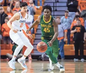  ?? ROB FERGUSON/USA TODAY SPORTS ?? Baylor guard Davion Mitchell dribbles past Oklahoma State guard Lindy Waters III during their game at Gallagher-Iba Arena.