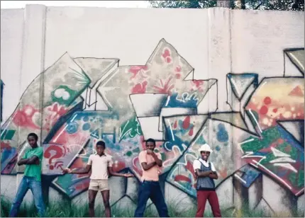  ?? COURTESY ?? Ahhh, the good old days. Four members of the United Kings — (from left) Fernando Alexander, Hackwin Devoe, Dwayne Devoe and Dexter Gilmore — strike a pose in front of their piece next to Arts Center Station in 1985. They recently reunited to participat­e in Atlanta Beltline’s second annual ATL Jam.