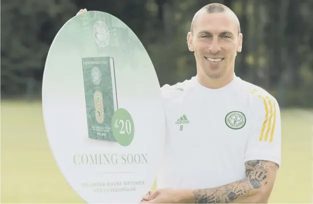  ??  ?? 0 Celtic captain Scott Brown took time out from training to promote the club’s forthcomin­g book ‘The Official Story of Nine In A Row’ which looks back over each campaign.