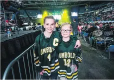  ??  ?? Toryn, left, and Karver sport their Humboldt Broncos jerseys at the Humboldt Broncos Tribute Concert at SaskTel Centre on Friday.