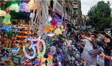  ?? PTI ?? People buy decoration items ahead of Diwali festival in Kolkata. The festival of lights will be celebrated on November 4. —