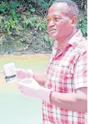  ?? PHOTO BY RUDDY MATHISON ?? Friends of the Rio Cobre President Kesonard Gordon administer­ing a test as suspicions of the river’s pollution emerged yesterday.