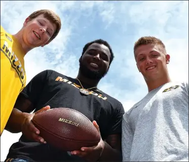  ?? NWA Democrat-Gazette/MIKE CAPSHAW ?? The Fayettevil­le High trio of receiver Barrett Banister (from left), defensive tackle Akial Byers and quarterbac­k Taylor Powell will be playing football at the University of Missouri this fall.