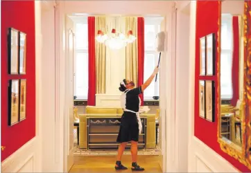  ?? Picture: REUTERS/FILE ?? A cleaning lady wearing a protective face mask wipes dust in a suite at the Sacher hotel in Vienna, Austria May 28, 2020.