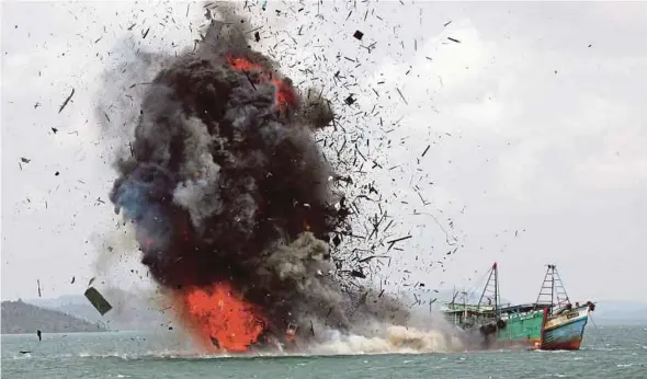  ?? AP PIC ?? Debris flying into the air as foreign fishing boats are blown up by the Indonesian Navy off Batam Island on Feb 22 last year.