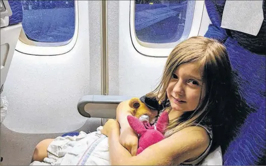  ?? HEATHER SZILAGYI PHOTO ?? Seven-year-old Molly Reid is seen on a British Airways flight on Oct. 10 in this handout photo. Heather Szilagyi, her seven-year-old daughter Molly and fiancee Eric Neilson when they spotted bedbugs crawling out of the seat in front of them on a flight...