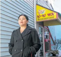  ?? RYAN TAPLIN/SALTWIRE NETWORK ?? Sophie Luo stands outside her Ho-Ho Wok restaurant in downtown Truro on Monday. The restaurant is closing for a couple of weeks after the owners went to Hong Kong for the Lunar New Year. They say they’re reacting to comments from the community about the coronaviru­s.