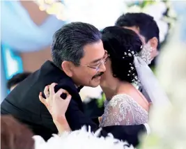  ??  ?? OPPOSITE PAGE Amir Faris and Wan Farah Diyana cutting their wedding cake; the bride’s parents, Datin Jude and Datuk Wan Fusil