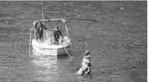  ?? MIKE CARROCCETT­O/OTTAWA CITIZEN ?? A police boat searches the Gatineau River in Wakefield on Friday. A 23-yearold man’s body was found near the Wakefield covered bridge where people gather to swim.