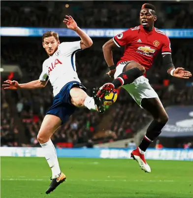  ?? — AFP ?? Aerial attack: Manchester United midfielder Paul Pogba (right) vying for the ball with Tottenham defender Jan Vertonghen during the English Premier League match at Wembley on Wednesday.