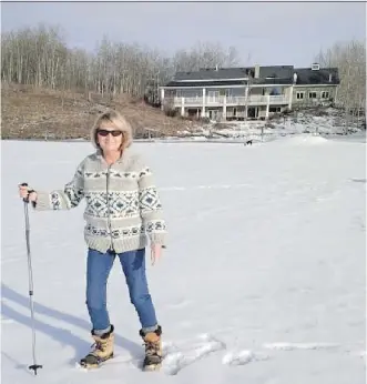  ??  ?? After years of battling and $170,000, Mary Lou Erik will be able to legally use the pond next to her Bearspaw house after a neighbour blocked it off with a fence.