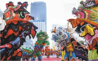  ?? Amy Osborne / Special to The Chronicle ?? Lion dancers celebrate Lunar New Year on Tuesday in San Francisco. Festivitie­s celebratin­g the arrival of the Year of the Pig go on for several days around the Bay Area.