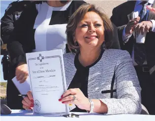  ?? SUSAN MONTOYA BRYAN/THE ASSOCIATED PRESS ?? Gov. Susana Martinez holds signed legislatio­n that expands access to the opioid overdose antidote naloxone Thursday in Albuquerqu­e. While that bill got a green light, Martinez vetoed more than 51 percent of the 277 bills that cleared the Legislatur­e...
