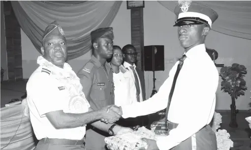  ??  ?? Commander, 330 Nigeria Air Force, Air Commodore Emmanuel Ozoemena (left), presenting an award to the best student, Mr Umaru Farouk, during the 29th Air Force Military School passing out parade in Jos yesterday.