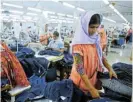  ?? /Reuters ?? Exports: Workers sort clothes at a company in Savar, Bangladesh. Ready-made garments account for almost 16% of the country’s GDP.