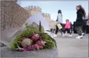  ?? ALBERTO PEZZALI — THE ASSOCIATED PRESS ?? Flowers are left outside Windsor Castle in Windsor, England, on Saturday. Britain's Kate, Princess of Wales's revelation she is undergoing treatment for cancer has sparked an outpouring of support and well wishes.