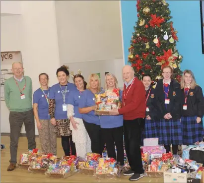  ??  ?? Con Shanahan and Kevin Mulligan, St. Vincent de Paul, Dundalk receiving much-needed donations from members of staff in PayPal along with teachers, and TY Students of St. Vincent’s Secondary School last year.