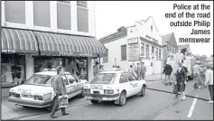  ??  ?? Police at the end of the road outside Philip James menswear