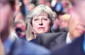  ?? BEN STANSALL/AFP ?? Britain’s Prime Minister Theresa May listens to Chancellor of the Philip Hammond speaking at the Conservati­ve party conference in Manchester on October 2.