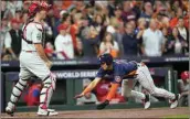  ?? DAVID J. PHILLIP / AP ?? Houston Astros’ Jeremy Pena scores on an RBI double hit by Houston Astros’ Yordan Alvarez during the first inning in Game 2 of baseball’s World Series between the Houston Astros and the Philadelph­ia Phillies on Saturday in Houston.