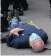  ?? Reuters ?? MARTIN Gugino, a 75-year-old protester, lies on the ground after he was shoved by two Buffalo, New York, police officers during a protest against the death in Minneapoli­s police custody of George Floyd in Niagara Square in New York, on Thursday. |