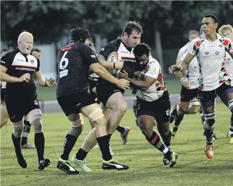  ?? Satish Kumar for the National ?? Dubai Exiles, in black, won another physical showdown with Harlequins to claim the UAE Premiershi­p title