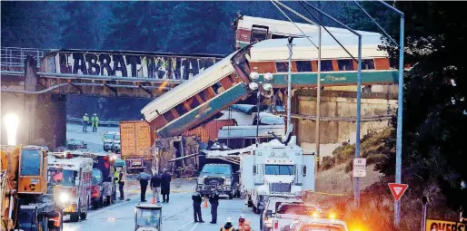  ?? [AP PHOTO] ?? Cars from an Amtrak train that derailed lie spilled onto Interstate 5 on Monday, in DuPont, Wash. The derailment killed several people, authoritie­s said.