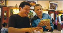  ?? NETFLIX ?? Kenji Lopez-alt, left, and Phil Rosenthal enjoy the cuisine at La Torta Gorda in San Francisco in the first episode of the new season of Netflix’s “Somebody Feed Phil.”