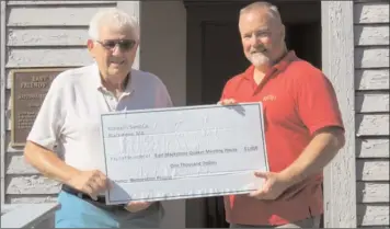  ?? Submitted photo ?? Wayne Kimball, right, of Kimball's Sand Company presents a check for $1,000 to Ellery Wood, president of the East Blackstone Quaker Meeting House & Cemetery Historical Associatio­n. The Quaker Meeting House, which is listed in the State Register of...