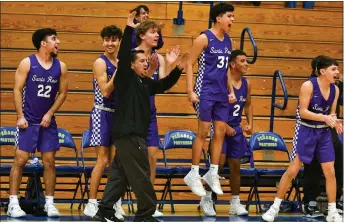  ?? JOHN T. DENNE ?? Santa Rosa Lions’ bench, along with head coach Joseph Esquibel, reacts after teammate Marcos Chavez went coast to coast for the game-winning basket against the Peñasco Panthers.