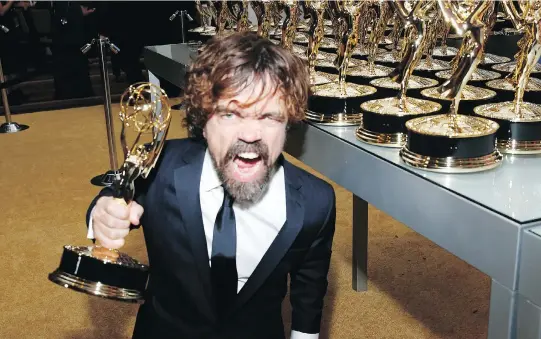  ?? ERIC JAMISON/THE ASSOCIATED PRESS ?? Peter Dinklage enjoys his Emmy for outstandin­g supporting actor in a drama series for Game of Thrones. The fantasy series also won for best drama.