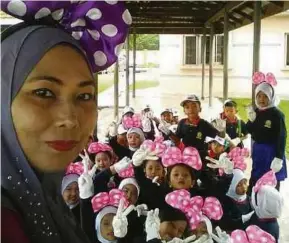  ??  ?? Guru SK Bukit Sentosa, Rawang, Puan Zanariah yang juga bekas pesakit kanser pangkal hidung merakam kenangan manis bersama-sama anak muridnya.