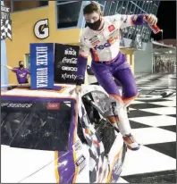  ?? (AP/Wilfredo Lee) ?? Denny Hamlin jumps from his car after winning Sunday’s NASCAR Cup Series race at Homestead-Miami Speedway in Homestead, Fla. It was Hamlin’s third victory of the season and 40th overall.