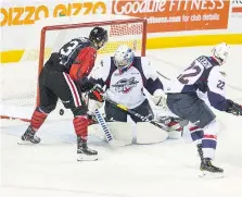  ?? JULIE JOCSAK/ST. CATHARINES STANDARD ?? Karl Piiroinen of the Spits defends against Kirill Maksimov of the IceDogs in St. Catharines on Friday.