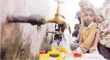  ??  ?? People collect drinking water from charity tap amid fears of a new cholera outbreak in Sanaa. — Reuters