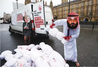  ?? (Reuters) ?? ACTIVISTS STAGE a protest timed to coincide with the visit by Saudi Crown Prince Mohammad bin Salman, also mocking British Prime Minister Theresa May, outside Parliament in London on March 7.