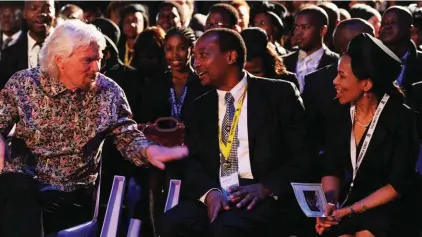  ??  ?? In this Dec. 15, 2013 file photo, British entreprene­ur Richard Branson, left, speaks to South African billionair­e Patrice Motsepe, centre, and his wife Precious Makgosi Moloi