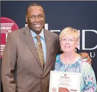  ?? Submitted photo ?? 40 YEARS: Henderson State University President Glen Jones, left, recently congratula­ted retiree Sandy Rogers, administra­tive specialist for the Multimedia Learning Center, for 40 years of service to the school. Jones was also recognized for his five...