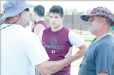  ?? Graham Thomas/Herald-Leader ?? Siloam Springs linebacker Braden Smartt looks on as co-defensive coordinato­rs Dwain Pippin, left, and Tony Coffee, right, have a discussion Monday night during 7-on-7 action at Panther Stadium. The Panthers will host two more 7-on-7 sessions on July 17...