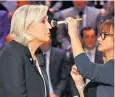  ??  ?? Candidate Marine Le Pen has her make-up touched up before the televised debate