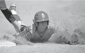  ?? BRYAN TERRY/THE OKLAHOMAN ?? Dale's Dayton Forsythe beats the tag to first base in the fifth inning of a Class 2A state semfinal game Friday against Oktaha.