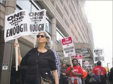  ?? Steven Senne Associated Press ?? WORKERS picket at a Westin hotel in Boston in October. The strike ended after the hotel union said it won contract improvemen­ts. Among the demands by Southern California workers is a $25-an-hour wage.