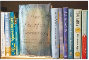  ?? (NWA Democrat-Gazette/J.T. Wampler) ?? It’s hard to say which of these books cost the most, but this first edition of “Her Fearful Symmetry” by Audrey Niffenegge­r is among the most priceless. It was a wedding gift, and Wallace’s favorite book to date.