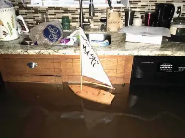  ?? Ramit Plushnick-Masti via AP ?? n This photo provided by Ramit Plushnick-Masti shows a toy sailboat floating in the kitchen of her flooded home Sunday in Houston’s Meyerland neighborho­od. Plushnick-Masti and her family intended to ride out Tropical Storm Harvey in their Houston home,...