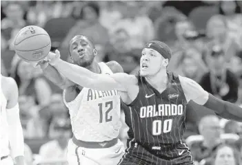  ?? JOHN RAOUX/AP ?? Aaron Gordon, right, and the Orlando Magic have been one of the NBA's top defensive teams the past two months.