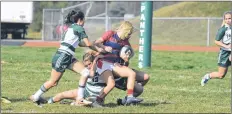  ?? JASON MALLOY/THE GUARDIAN ?? It took a couple of UPEI Panthers to take Acadia Axewomen Emilie Merilainen down during Atlantic University Sport rugby action in Charlottet­own.