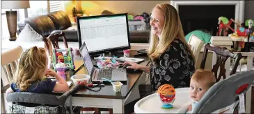  ?? CURTIS COMPTON / CCOMPTON@AJC.COM ?? Samantha Gygax, demand planner for High Road Craft Ice Cream, works in her Roswell home Tuesday. She fears kids may never know the world that was before. “The girls are so young that they don’t really know what’s going on – other than mommy and daddy are home all the time.”