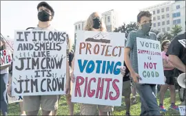  ?? JOSE LUIS MAGANA — THE ASSOCIATED PRESS ?? Demonstrat­ors hold signs during a march for voting rights Saturday in Washington.