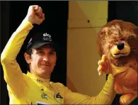  ?? AP/CHRISTOPHE ENA ?? Britain’s Geraint Thomas takes a 1 minute, 51 second lead into today’s mostly ceremonial final stage of the Tour de France on the Champs-Elysees in Paris.